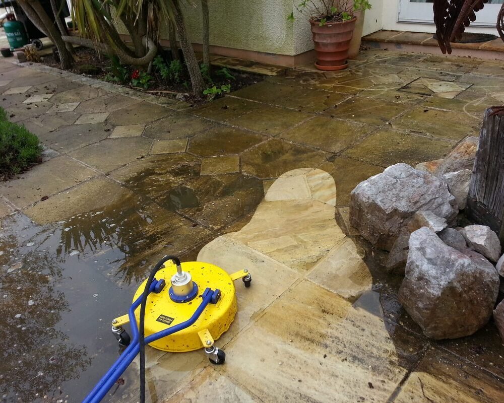 Pressure washing team using high-pressure water to clean building exterior in York